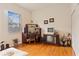 Bedroom with wood floors, large window and closet, furnished with desk and old television at 3440 Tumbling River Dr, Clermont, FL 34711