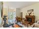 Entryway featuring hardwood floors, decorative glass front door, and a view into the living room at 3440 Tumbling River Dr, Clermont, FL 34711