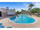 The community pool is surrounded by palm trees and offers a beautiful place to relax at 3440 Tumbling River Dr, Clermont, FL 34711