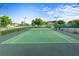 Outdoor community tennis court with green surface and net at 3440 Tumbling River Dr, Clermont, FL 34711
