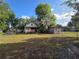 Spacious, fenced yard with mature trees, providing a private and tranquil outdoor setting at 350 Cassady St, Umatilla, FL 32784