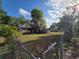 Exterior home view with a large backyard and a covered porch at 350 Cassady St, Umatilla, FL 32784