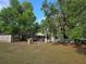 Spacious backyard with a brick bbq pit and mature trees offers ample outdoor living space at 350 Cassady St, Umatilla, FL 32784