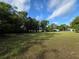 Vast, grassy land parcel surrounded by mature trees, offering a serene setting at 350 Cassady St, Umatilla, FL 32784