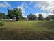 Open land parcel with mature trees in a neighborhood setting at 350 Cassady St, Umatilla, FL 32784