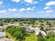 Wide aerial view of community featuring well manicured lawns and mature trees at 3800 Woodleaf Ct, Leesburg, FL 34748