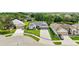 Aerial view of a well-maintained home with a two-car garage and manicured lawn in a serene neighborhood at 3800 Woodleaf Ct, Leesburg, FL 34748