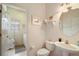 Half bathroom featuring a toilet, sink, and decorative decor, near laundry room at 3800 Woodleaf Ct, Leesburg, FL 34748