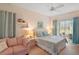 Cozy bedroom featuring a comfortable bed, sofa, and sliding doors to the outside at 3800 Woodleaf Ct, Leesburg, FL 34748
