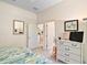 View of the bedroom with twin beds leading to the bathroom and kitchen area at 3800 Woodleaf Ct, Leesburg, FL 34748