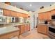 Functional kitchen with ample cabinet space, tile flooring, and stainless steel appliances at 3800 Woodleaf Ct, Leesburg, FL 34748