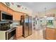 Bright kitchen features stainless steel appliances, a breakfast nook, and tile flooring at 3800 Woodleaf Ct, Leesburg, FL 34748
