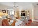 Inviting living room featuring hardwood floors, comfortable seating, and a large display cabinet at 3800 Woodleaf Ct, Leesburg, FL 34748