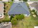 Backyard view of a home with a screened patio, well-maintained landscaping and a neatly trimmed lawn at 3942 Zenith Loop, The Villages, FL 32163