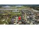 Aerial view of a home near a golf course, surrounded by lush greenery and waterways in a vibrant community at 3942 Zenith Loop, The Villages, FL 32163