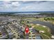 Aerial view of a residential area close to a golf course, showing the home's proximity to community amenities at 3942 Zenith Loop, The Villages, FL 32163