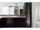 Bathroom featuring dark cabinets, granite countertops, single sink, and ample storage space at 3942 Zenith Loop, The Villages, FL 32163