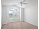 Bright bedroom with a ceiling fan, carpet floors and a large window with exterior views at 3942 Zenith Loop, The Villages, FL 32163