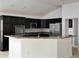 Well-equipped kitchen featuring stainless steel appliances, dark cabinetry, and spacious countertops at 3942 Zenith Loop, The Villages, FL 32163