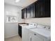 Laundry room featuring a washing machine, dryer, cabinets, sink, and window at 3942 Zenith Loop, The Villages, FL 32163