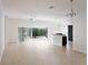 Open-concept living room with sliding glass doors leading to a patio and plenty of natural light at 3942 Zenith Loop, The Villages, FL 32163