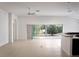 Open living space with large sliding glass doors and neutral tile flooring at 3942 Zenith Loop, The Villages, FL 32163
