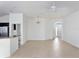 Bright and airy living room with tile flooring, a ceiling fan, and open access to other rooms at 3942 Zenith Loop, The Villages, FL 32163
