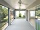 A screened patio provides a tranquil outdoor space with views of the lush landscaped backyard at 3942 Zenith Loop, The Villages, FL 32163