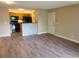 Open living area with kitchen views, tile breakfast bar, and light hardwood floors at 420 Forestway Cir # 206, Altamonte Springs, FL 32701
