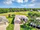 Stunning aerial view of a home showcasing lush landscaping and a beautiful golf course backdrop on a sunny day at 4247 James River Cir, Leesburg, FL 34748