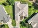 Aerial view of the home showing the roofline, driveway, and surrounding landscaping at 4247 James River Cir, Leesburg, FL 34748