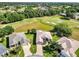Overhead view of the home, set within a golf course community with lush landscaping at 4247 James River Cir, Leesburg, FL 34748