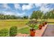 View of the lush backyard and golf course, offering a serene and picturesque outdoor setting at 4247 James River Cir, Leesburg, FL 34748