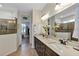 Bathroom featuring a double vanity, quartz countertop, and glass shower at 4247 James River Cir, Leesburg, FL 34748