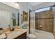 Bathroom showcases neutral walls, tile, a vanity with sink, and a tub/shower with decorative curtains at 4247 James River Cir, Leesburg, FL 34748