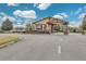 Elegant community entrance featuring manicured landscaping and a secure gatehouse at 4247 James River Cir, Leesburg, FL 34748