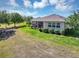 Spacious backyard view, including the screened lanai and manicured landscaping surrounding the home at 4247 James River Cir, Leesburg, FL 34748