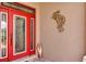 Elegant front door with decorative glass panels, accentuated by a unique wall art piece and a stylish side panel window at 4247 James River Cir, Leesburg, FL 34748