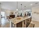 Spacious kitchen island with granite countertops, pendant lighting, and an open layout connecting to the inviting living space at 4247 James River Cir, Leesburg, FL 34748