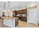 Kitchen with a granite countertop island, stainless steel appliances and dark wood cabinetry at 4247 James River Cir, Leesburg, FL 34748
