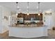 Spacious kitchen featuring a large island with granite countertops and stainless steel appliances at 4247 James River Cir, Leesburg, FL 34748
