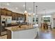 Spacious kitchen featuring a large granite island and stainless steel appliances at 4247 James River Cir, Leesburg, FL 34748