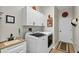 Laundry room features modern washer and dryer, sink and ample storage in white cabinets at 4247 James River Cir, Leesburg, FL 34748