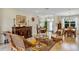 Comfortable living room with wicker furniture, decorative accents, and a seamless flow to the dining area, creating a cozy space at 4247 James River Cir, Leesburg, FL 34748