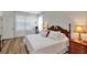 Bedroom featuring a large window and hardwood floors at 4247 James River Cir, Leesburg, FL 34748