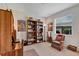 Comfortable office space with built-in bookshelves, large window and a cozy chair with footstool at 4247 James River Cir, Leesburg, FL 34748