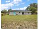 Spacious backyard with a well-maintained lawn and a cozy patio area, perfect for outdoor relaxation and entertaining at 425 Marion Oaks Dr, Ocala, FL 34473