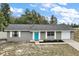 Charming single-story home featuring a bright blue front door and well-maintained landscaping at 425 Marion Oaks Dr, Ocala, FL 34473