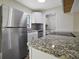 Well-appointed kitchen with stainless steel appliances, granite countertops, and white cabinetry at 425 Marion Oaks Dr, Ocala, FL 34473