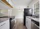 Modern kitchen featuring stainless steel appliances, granite countertops, and white cabinetry at 425 Marion Oaks Dr, Ocala, FL 34473